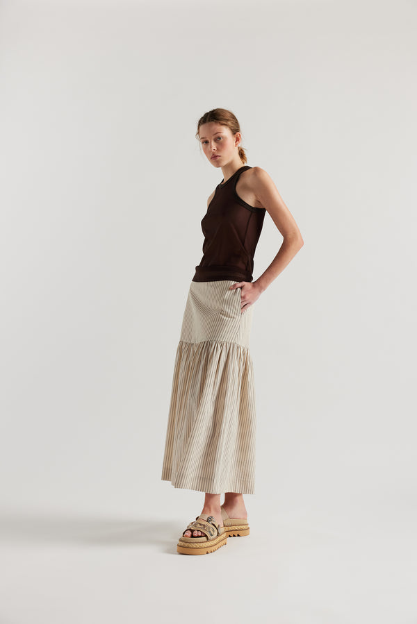 Front  angle of Model in the Ecru and Black Pin Stripe Panelled cotton skirt with gathered full silhouette, wide yoke waist, and invisible back zip closure.