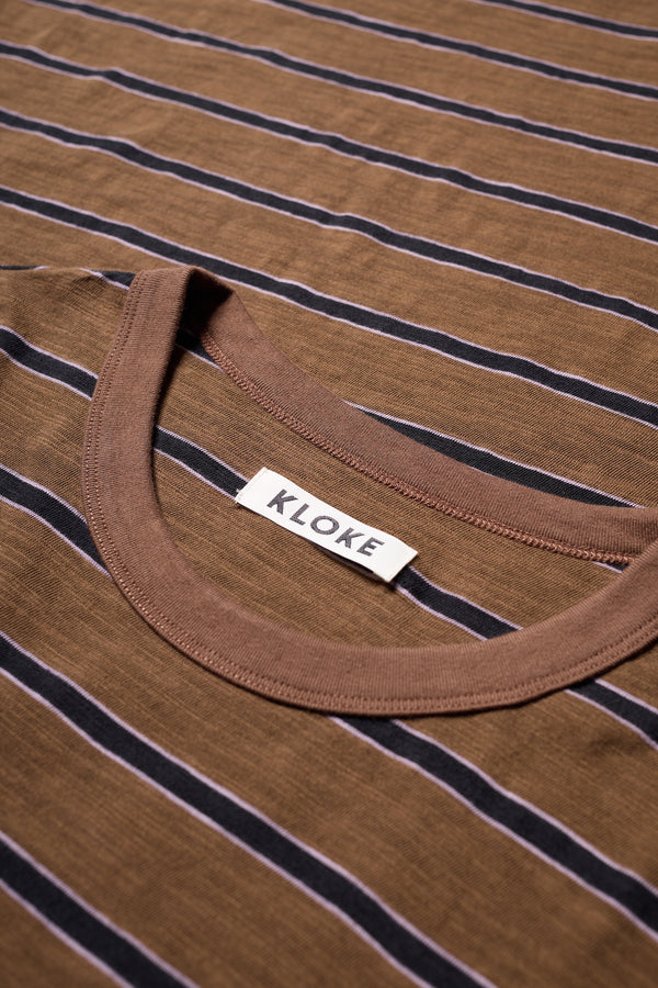 Close up fabric shot of the black/brown/lilac stripe, Obelisk Feeder Stripe Tee in yarn-dyed slub cotton with relaxed boxy fit