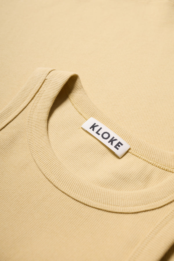 Close-up of ribbed Japanese cotton texture on Kloke racer-back tank in Pale Yellow