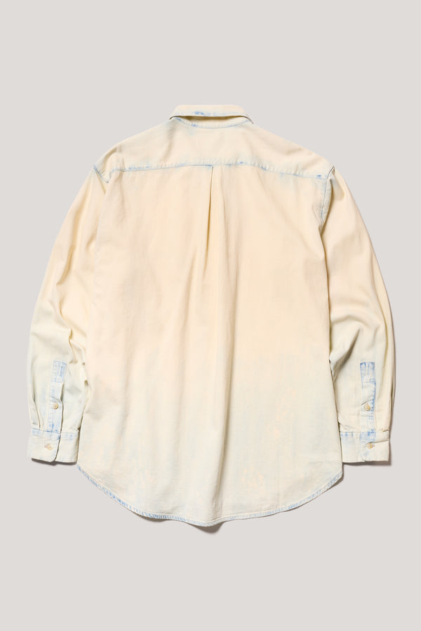 Back view of loose long sleeve Finite denim shirt in Mid blue fade with Ecru Tint. Highlighting centre back box pleat and rounded hem.