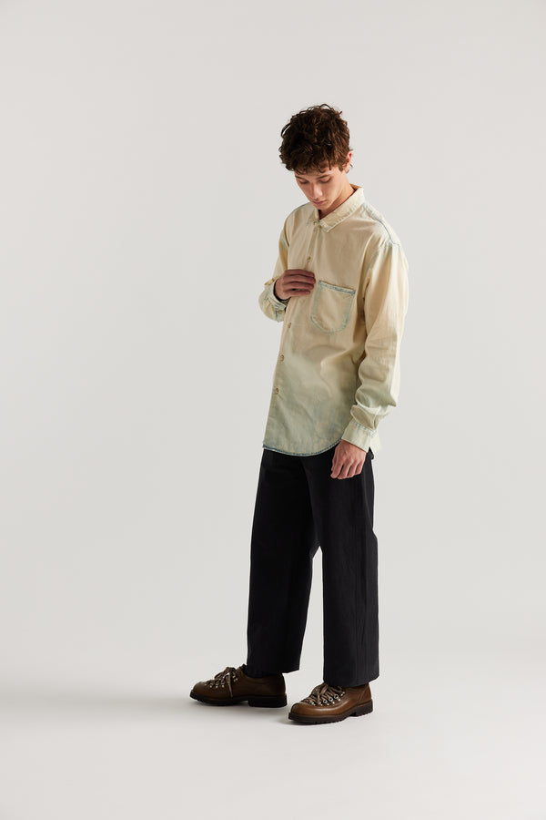 Loose long sleeve Mid-fade with Ecru Tint denim button-up shirt, front view showing built-in collar, centre button placket, and chest patch pocket with rivet details.
