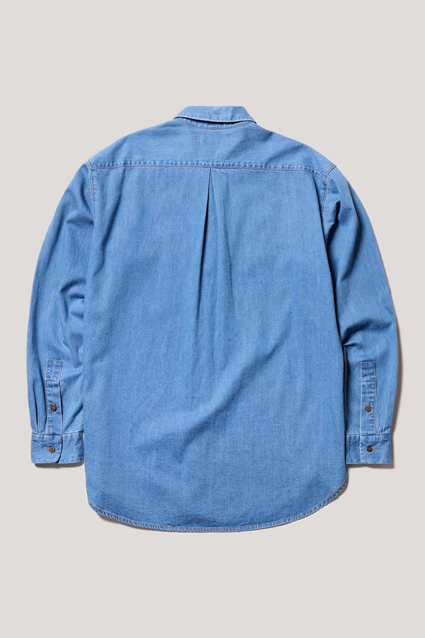 Back view of loose long sleeve Finite denim shirt in Mid Wash. Highlighting centre back box pleat and rounded hem.