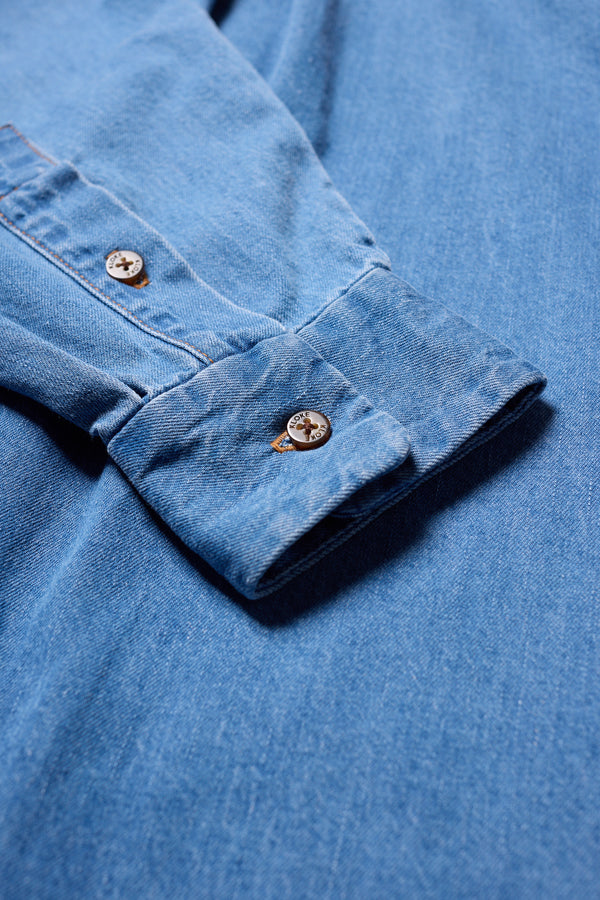 Close-up of the Mid Wash Finite denim shirt soft washed denim texture.