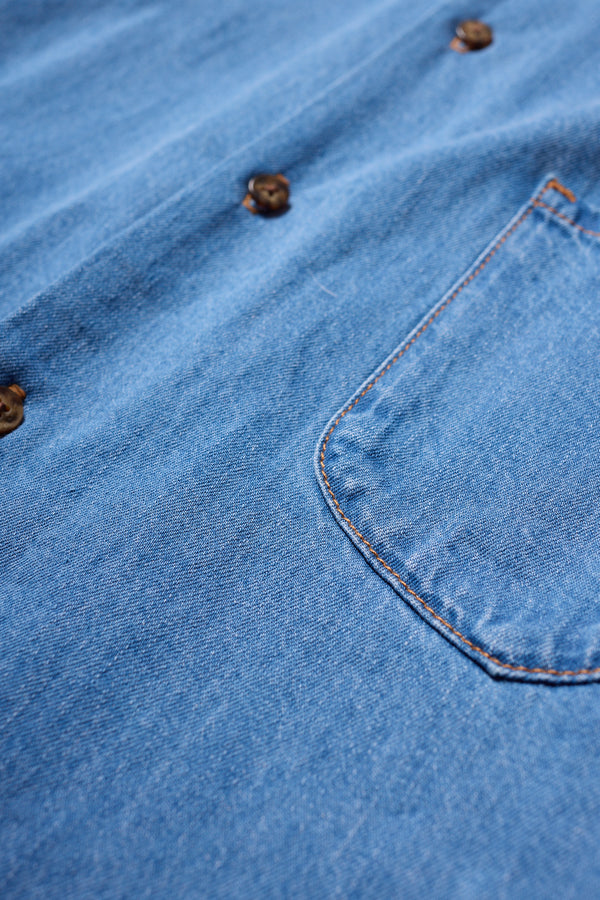 Close-up of the Mid Wash Finite denim shirt chest pocket with rivets and soft washed denim texture.