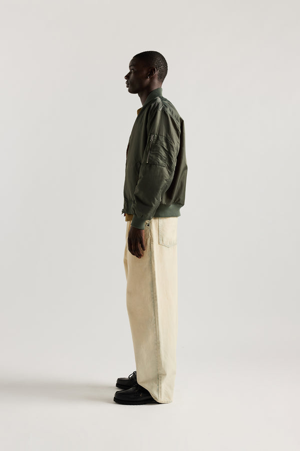 the Mid Blue Fade with Ecru Tint Impact Denim Pant in lightweight denim, front view showing wide tapered leg, elastic waistband, and traditional front pockets.