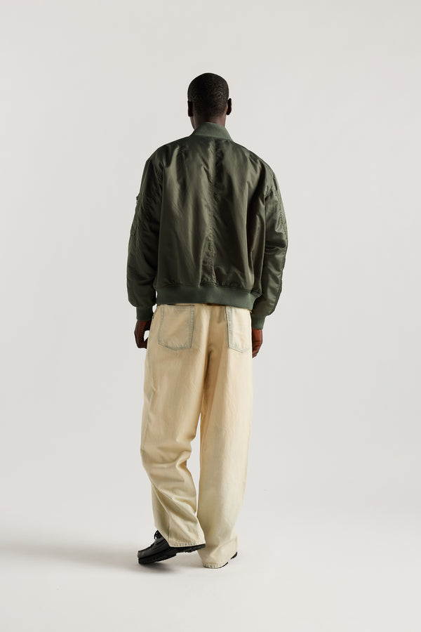 back of the Mid Blue Fade with Ecru Tint Impact Denim Pant in lightweight denim, front view showing wide tapered leg, elastic waistband, and traditional front pockets.