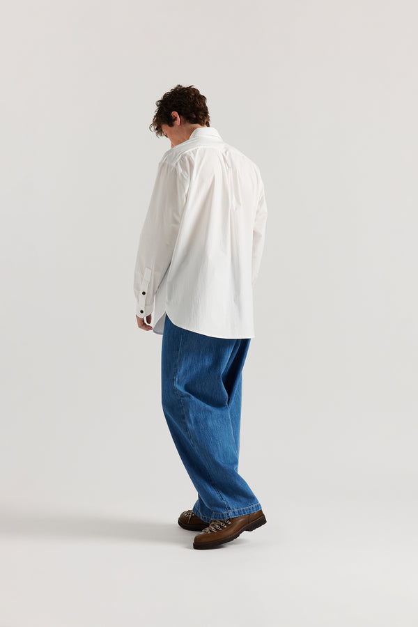 Back view of Mid Wash Impact Denim Pant highlighting back patch pockets and relaxed silhouette.