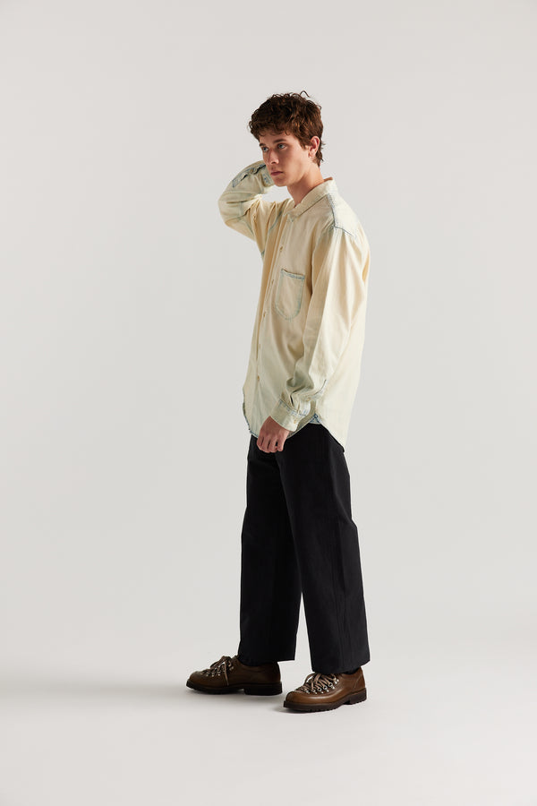 Front view of male model in Black Lenz Pant with straight-leg silhouette, front patch pockets and twin-needle topstitch detail.