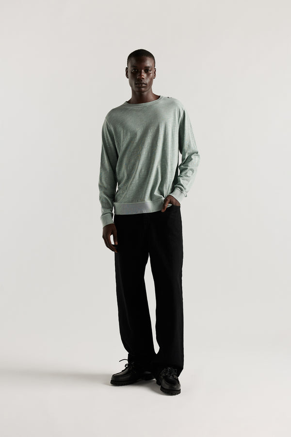 Front view of Ousmane in Black Lenz Pant with straight-leg silhouette, front patch pockets and twin-needle topstitch detail.