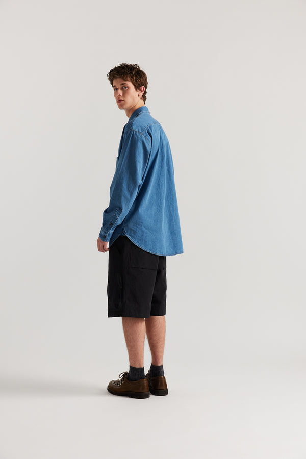 Back view of Luke in relaxed fit men’s cotton shorts in black showcasing 3D pocket construction, panel detailing, and structured laid-back design