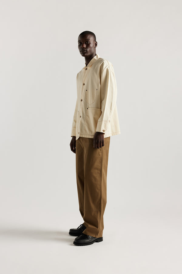 Front of male model wearing the Ecru Protocol Coverall in 100% cotton denim. 