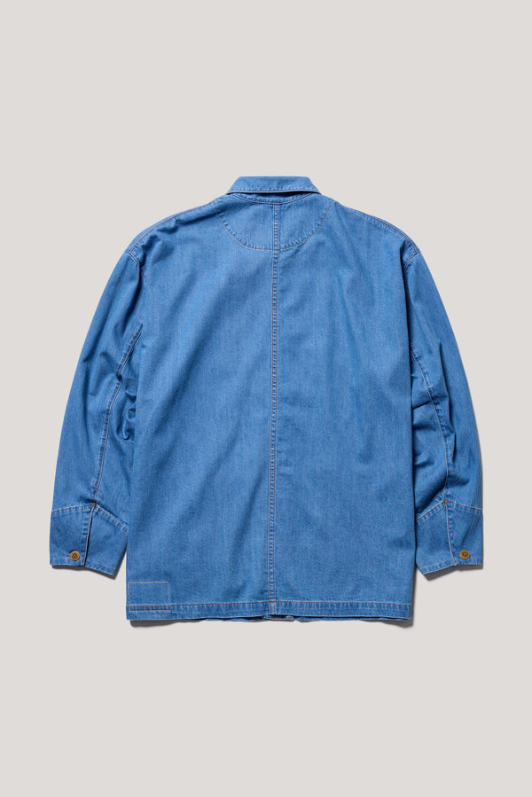 Flat back of the  Mid Wash Protocol Coverall in light 100% cotton denim highlighting two-piece sleeves and flat-felled seam detailing.