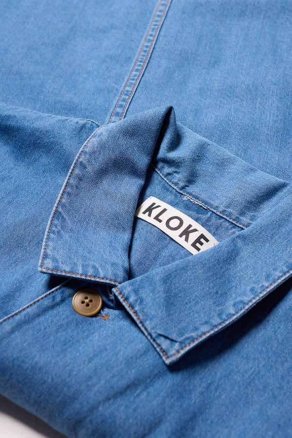 Close-up of Kloke Protocol Coverall in Mid Wash 100% cotton Denim, highlighting the  Built in Collar