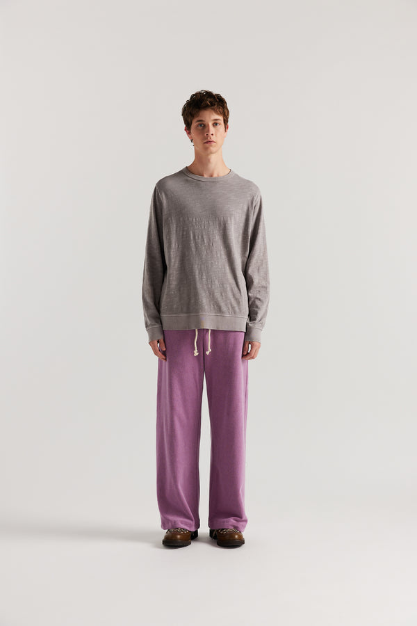 Men - Front view of slouchy track pants in purple cotton terry with straight-leg fit and cord-tie waistband.