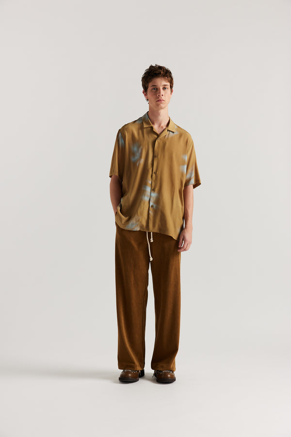 Men - Front view of slouchy track pants in coffee brown cotton terry with straight-leg fit and cord-tie waistband.