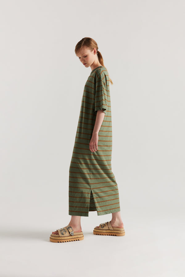 side of Model in the Olive/Brown Fidelity Dress in cotton slub with relaxed loose fit and feeder stripe