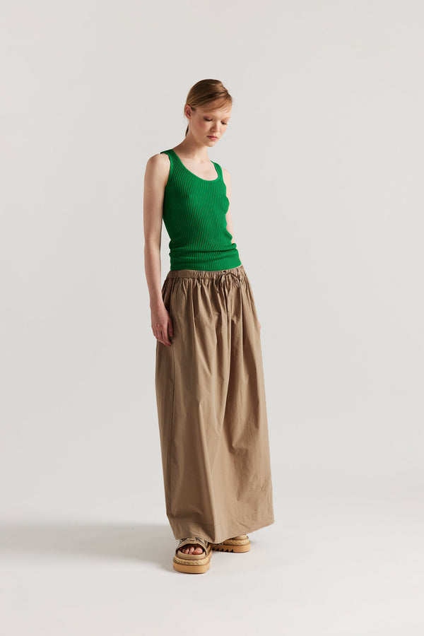 Front of Model wearing the green Duet Knit Singlet, showing the draped fit and textured knit.