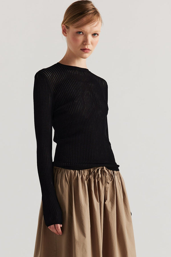 Front of model in Black Verse Knit Tee with subtle drop-stitch texture and fitted long-sleeve silhouette.