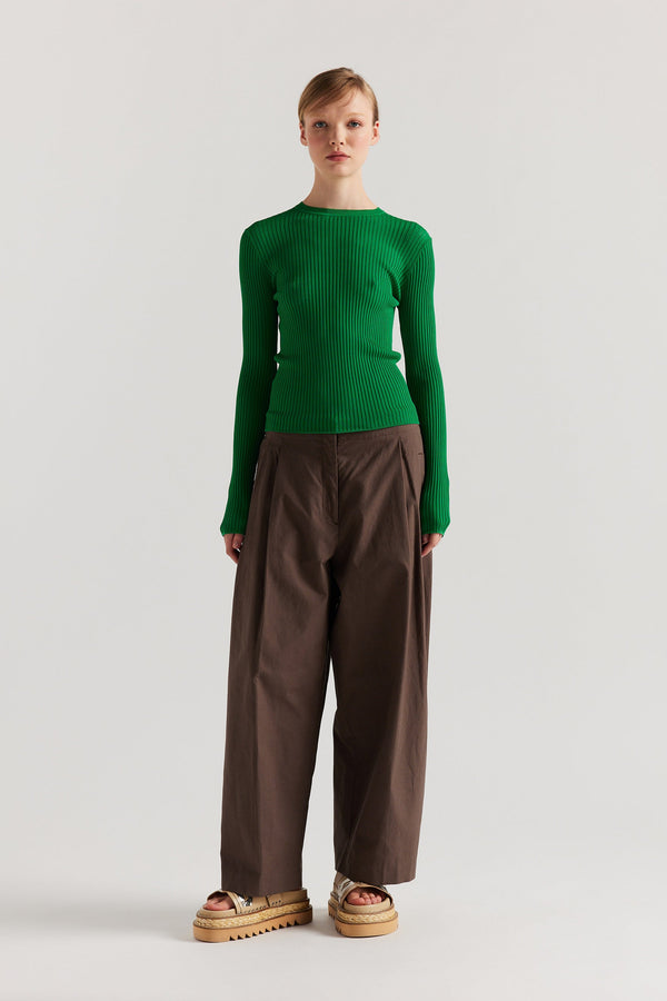 Front of model in Green Verse Knit Tee with subtle drop-stitch texture and fitted long-sleeve silhouette.