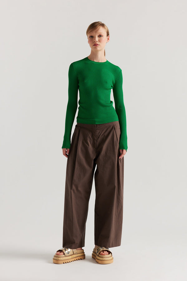Front of model in Green Verse Knit Tee with subtle drop-stitch texture and fitted long-sleeve silhouette.