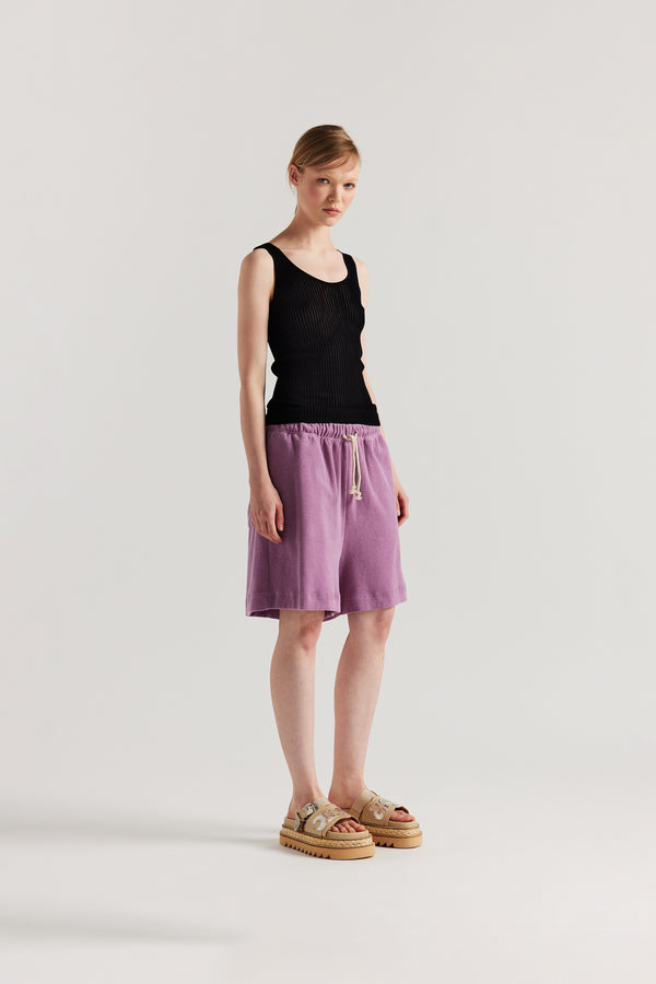 Front of Model wearing the Black Duet Knit Singlet, showing the draped fit and textured knit.