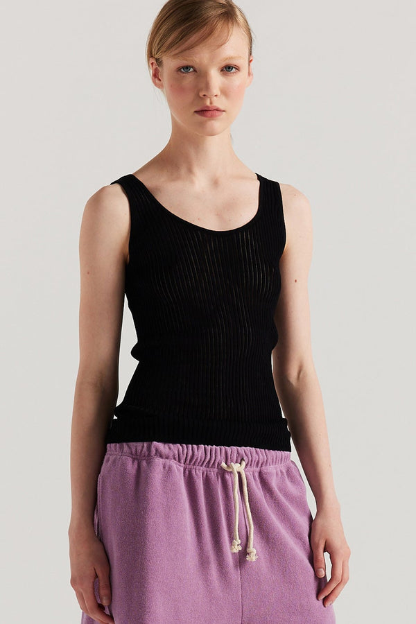 Front of Model wearing the Black Duet Knit Singlet, showing the draped fit and textured knit.