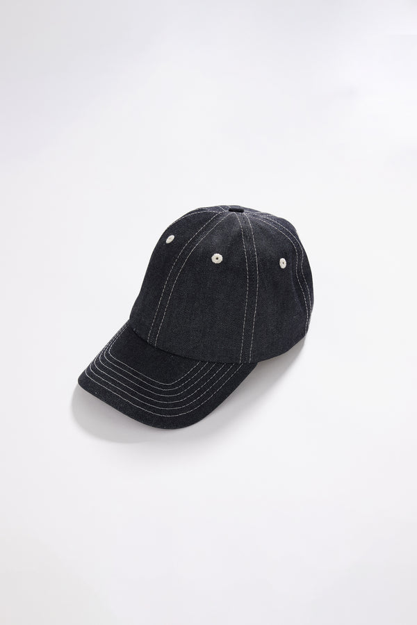 Unisex five-panel cap in premium 9oz Japanese dark indigo denim with contrast stitching.