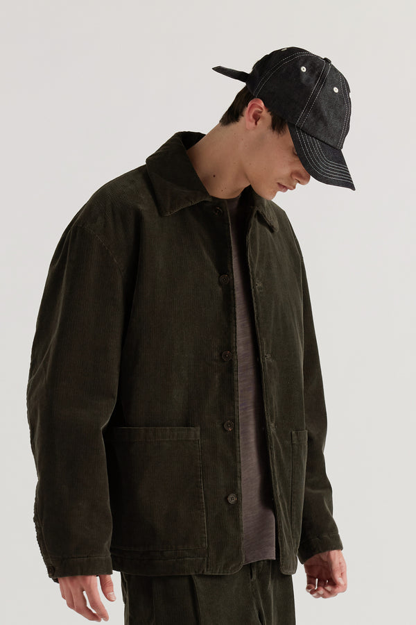 Men - front of male model in Unisex five-panel cap in premium 9oz Japanese dark indigo denim with contrast stitching.