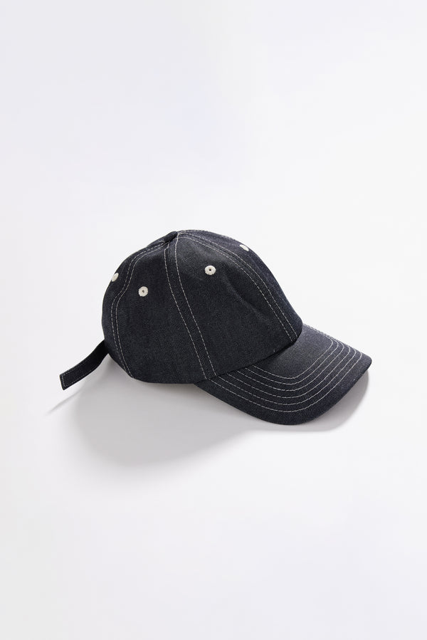 Unisex five-panel cap in premium 9oz Japanese dark indigo denim with contrast stitching.