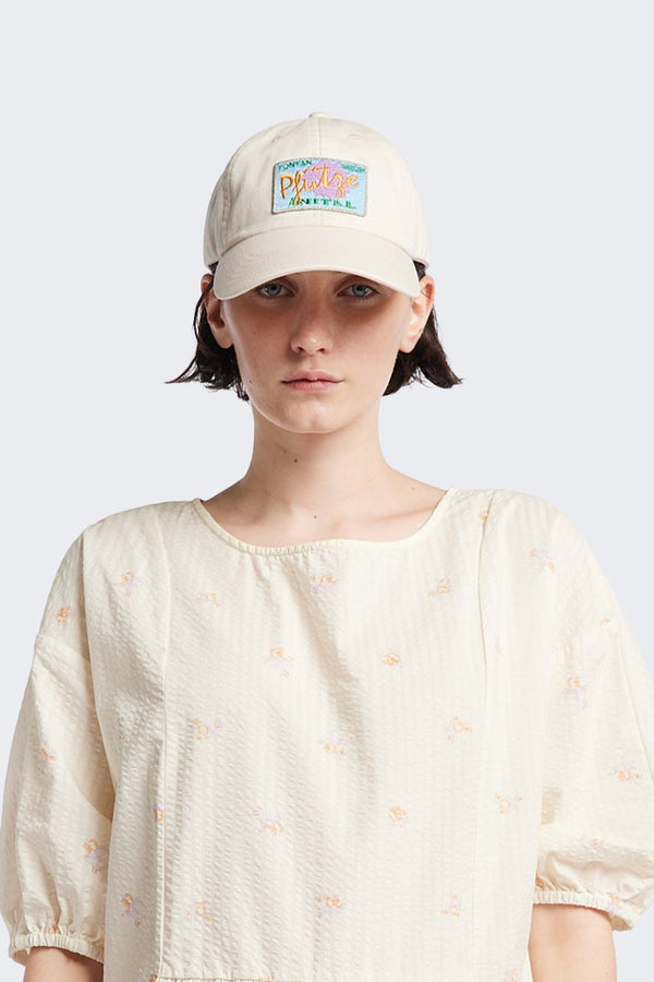 women - Unisex Cotton cap in Ecru Beige with Pfutze Aer Vital embroidered motif, adjustable fit with metallic buckle and ‘KLOKE’ embroidery on the strap. One Size.