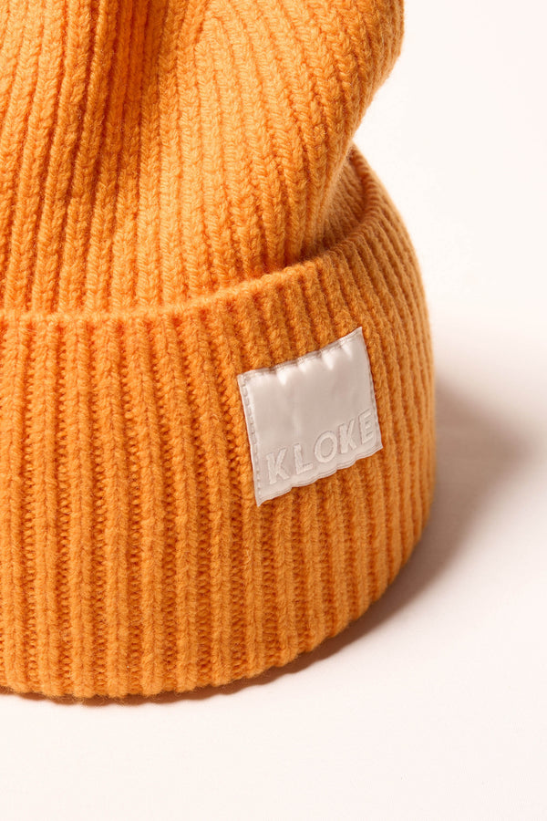Close up fabric shot of ribbed knit beanie showing texture in Dutch Orange