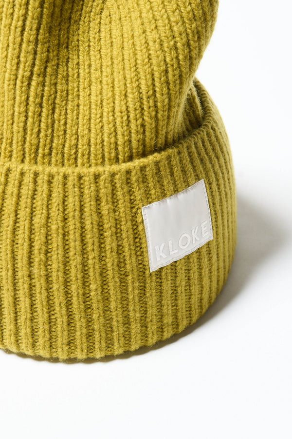 Close up fabric shot of ribbed knit beanie showing texture in Olive Oil 