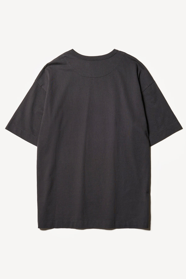 Flat Back of the Monolith Unisex Tee in Black. Oversized relaxed fit. Available in 6 sizes. Made from 100% Organic Cotton. 