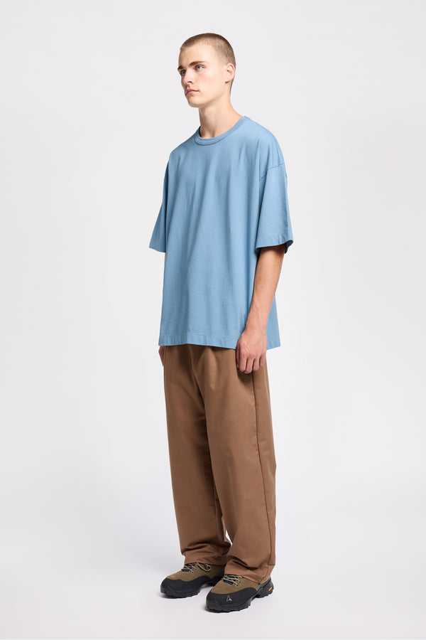 Men - front of model in Monolith Unisex Tee in Blue.  Oversized relaxed fit. Available in 6 sizes. Made from 100% Organic Cotton 