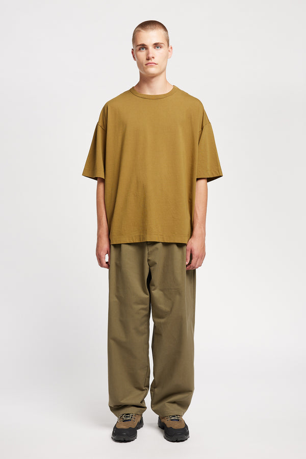 Men - front of model in Monolith Unisex Tee in Olive Oil.  Oversized relaxed fit. Available in 6 sizes.