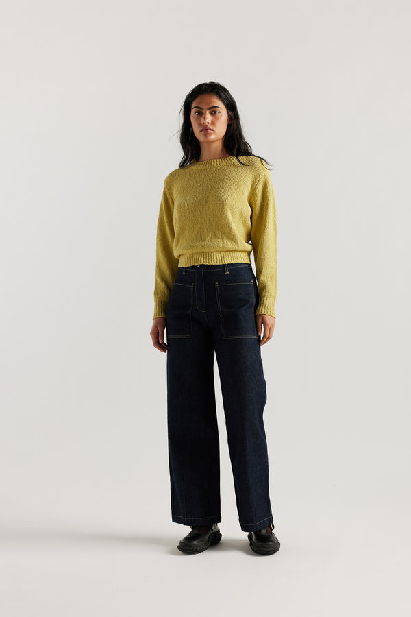 Front of female model in the straight wide-leg denim jeans indigo with a higher-rise waist, patch pockets, and back yoke detail, shown from the front.