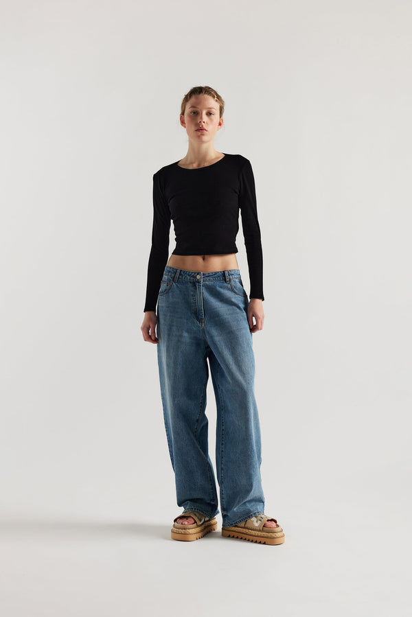 Front view of Model wearing Kloke straight-leg jeans in mid-blue Japanese denim, featuring a mid-rise waist and relaxed silhouette