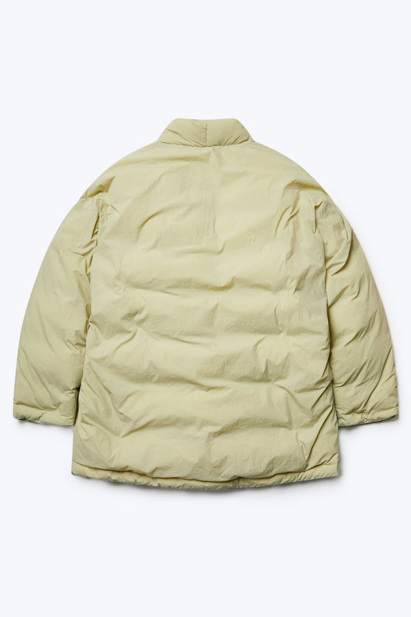 The back of the Abeyance Quilted Coat Sand, a puffer jacket made from 100% Recycled Nylon, Lining 100% Recycled Nylon, Fill 100% Post Consumer Down Fill