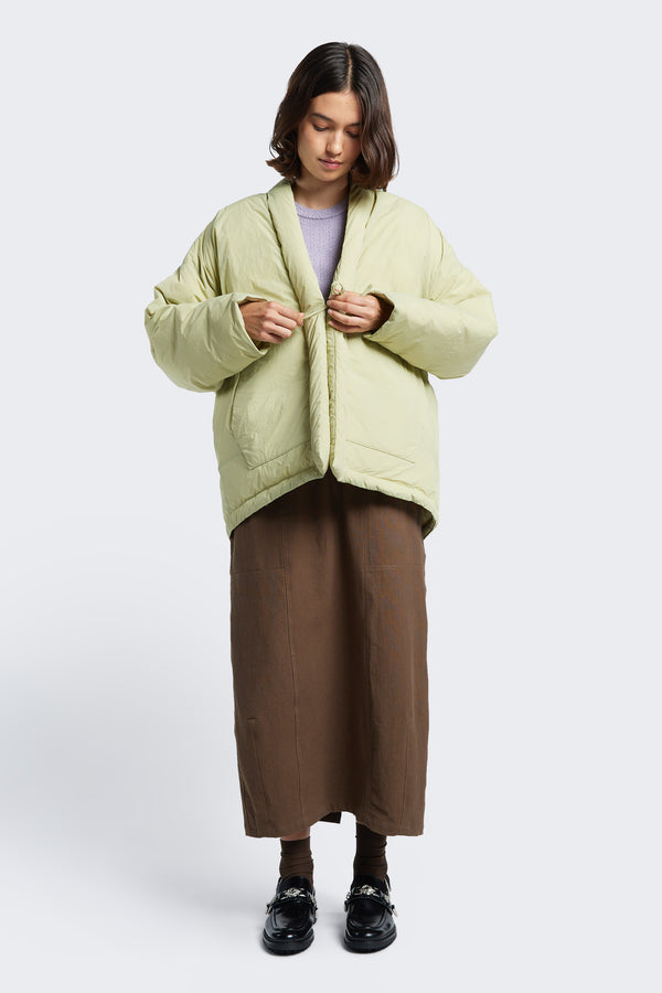 Model wears the Abeyance Quilted Coat Sand, a Kimono style puffer jacket with centre front self tie. Available in five sizes. 