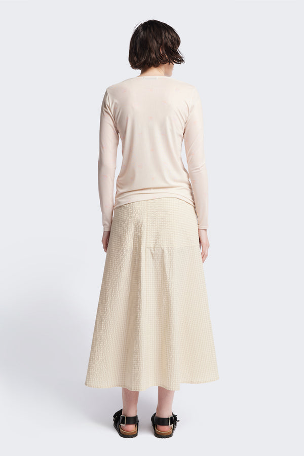 The back of the Abroad Panel Skirt, fitted at the waist with a bias-cut maxi silhouette, made from 100% cotton in Ecru Seersucker. Features panel details, side pockets, and an invisible back zip. Available in 6 sizes