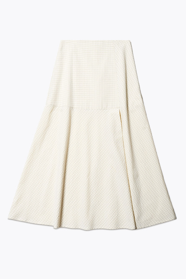 Abroad Panel Skirt, fitted at the waist with a bias-cut maxi silhouette, made from 100% cotton in Ecru Seersucker. Features panel details, side pockets, and an invisible back zip. Available in 6 sizes