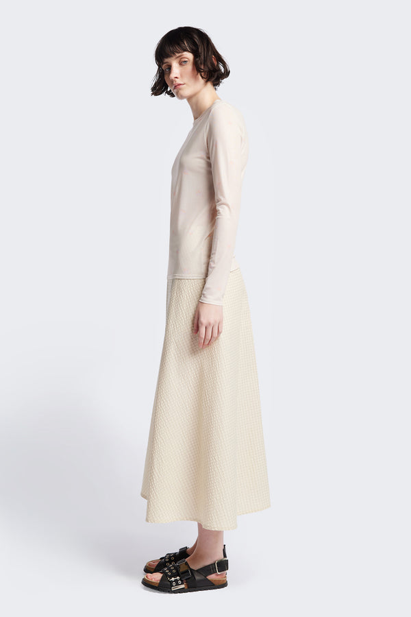 The Abroad Panel Skirt side view, fitted at the waist with a bias-cut maxi silhouette, made from 100% cotton in Ecru Seersucker. Features panel details, side pockets, and an invisible back zip. Available in 6 sizes