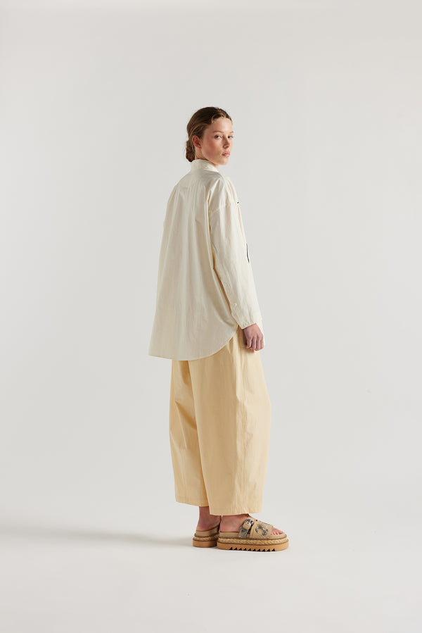 Ecru off white, Ache Embroidered Shirt back view on female model, with embroidered motifs, long sleeves, and built-in collar