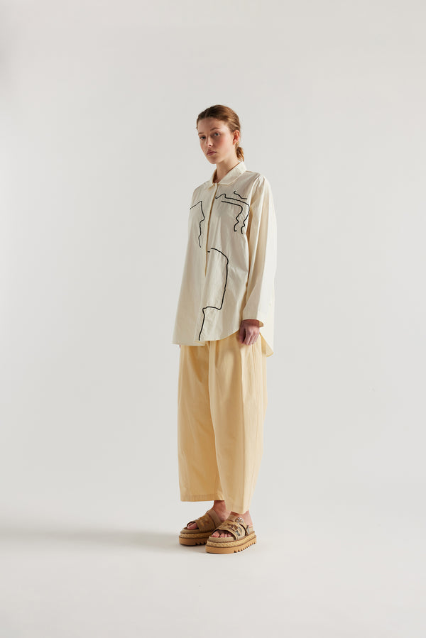 Ecru off white, Ache Embroidered Shirt front view on female model, with embroidered motifs, long sleeves, and built-in collar