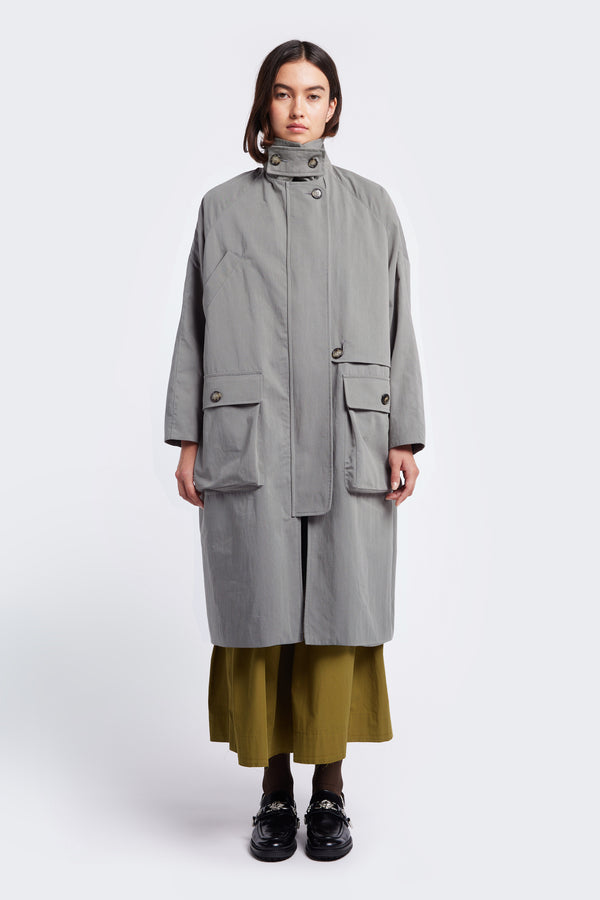 The Aegis Trench Grey is an oversized coat with round stand colour high, concealed centre front zip closed and pockets. 