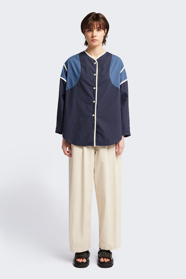 Front of The Ages shirt in blue, a Patchwork-style shirt with block colours, bound seams, rounded neckline, centre front button opening, and rounded hemline, offering a relaxed, modern fit