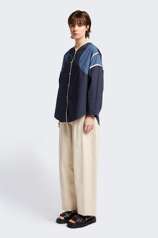 Front of The Ages shirt in blue, a Patchwork-style shirt with block colours, bound seams, rounded neckline, centre front button opening, and rounded hemline, offering a relaxed, modern fit