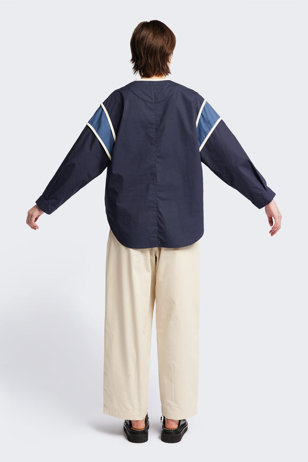 Back of The Ages shirt in blue, a Patchwork-style shirt with block colours, bound seams, rounded neckline, centre front button opening, and rounded hemline, offering a relaxed, modern fit