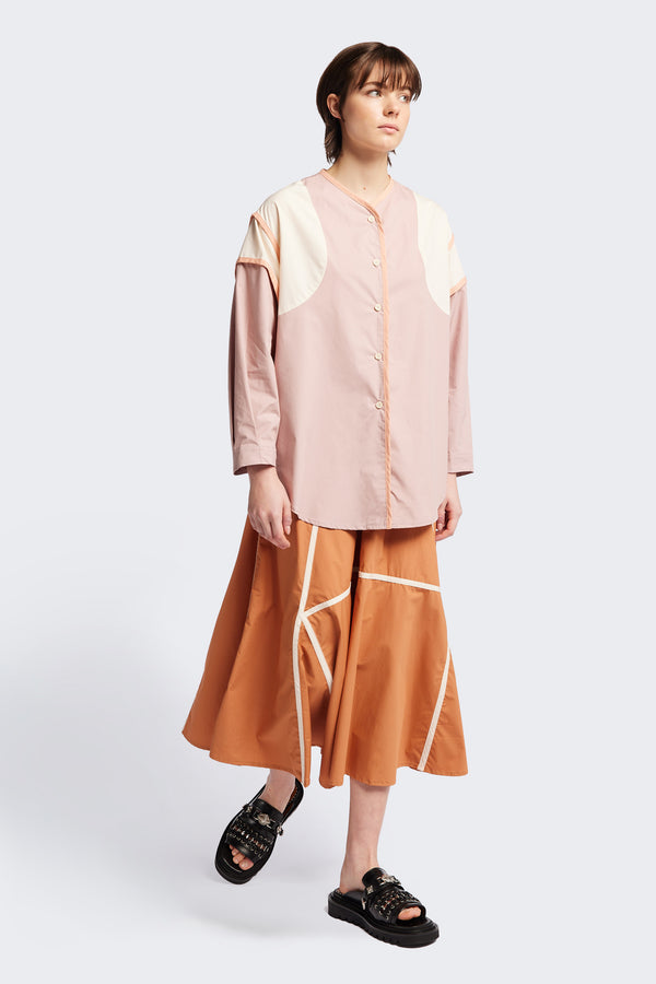 Front of The Ages shirt in peach, a Patchwork-style shirt with block colours, bound seams, rounded neckline, centre front button opening, and rounded hemline, offering a relaxed, modern fit