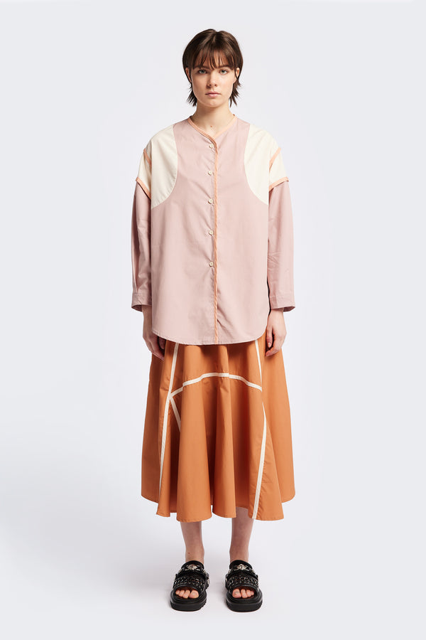 Front of The Ages shirt in peach, a Patchwork-style shirt with block colours, bound seams, rounded neckline, centre front button opening, and rounded hemline, offering a relaxed, modern fit